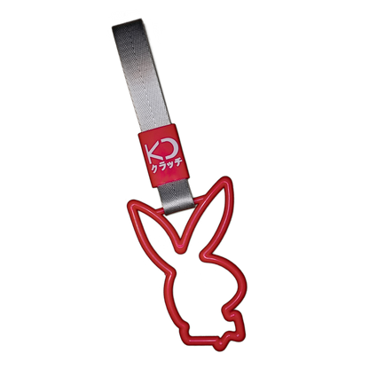 Red bunny drift charm or drift ring. Inspired by bus, train, and subway handles (or Tsurikawas) that were rebelliously repurposed for automotive decoration.